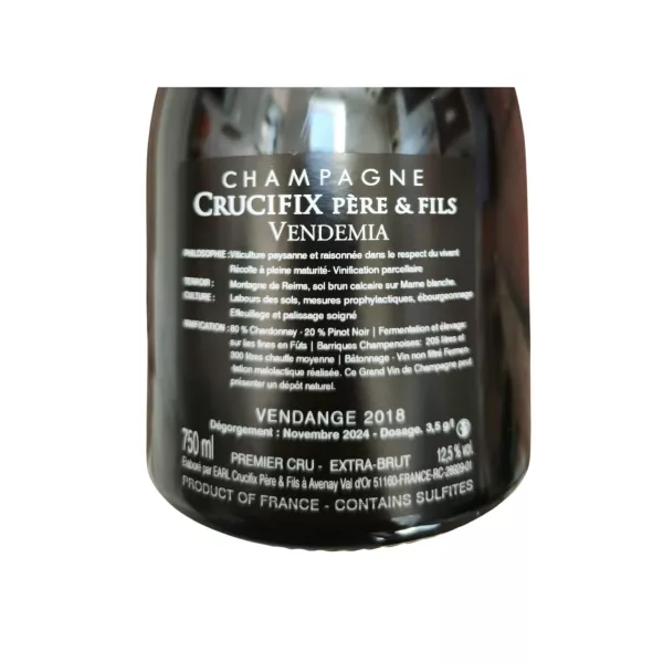 Back label Bottle of Champagne Crucifix Vendemia Extra-Brut Premier Cru, 80% Chardonnay, aged 60 months.